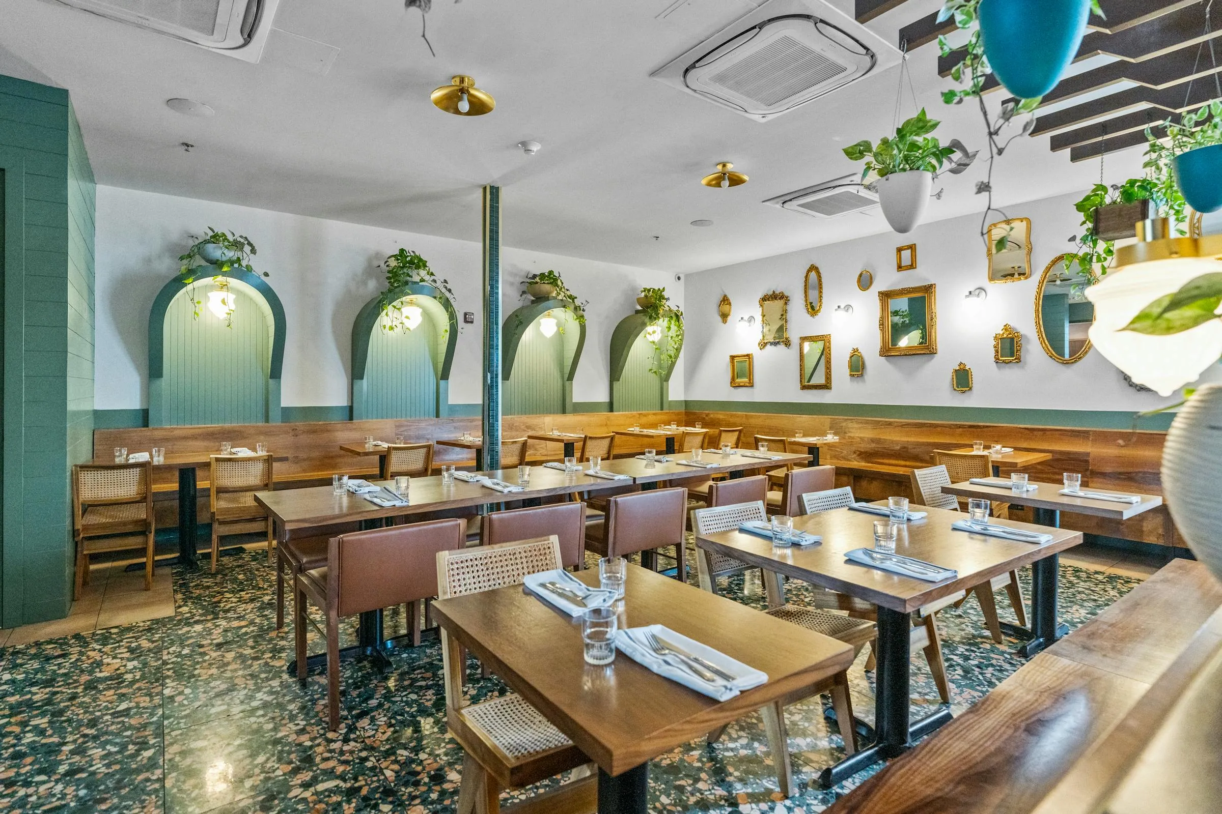 The Bar Luca dining room with green arches and gold mirrors